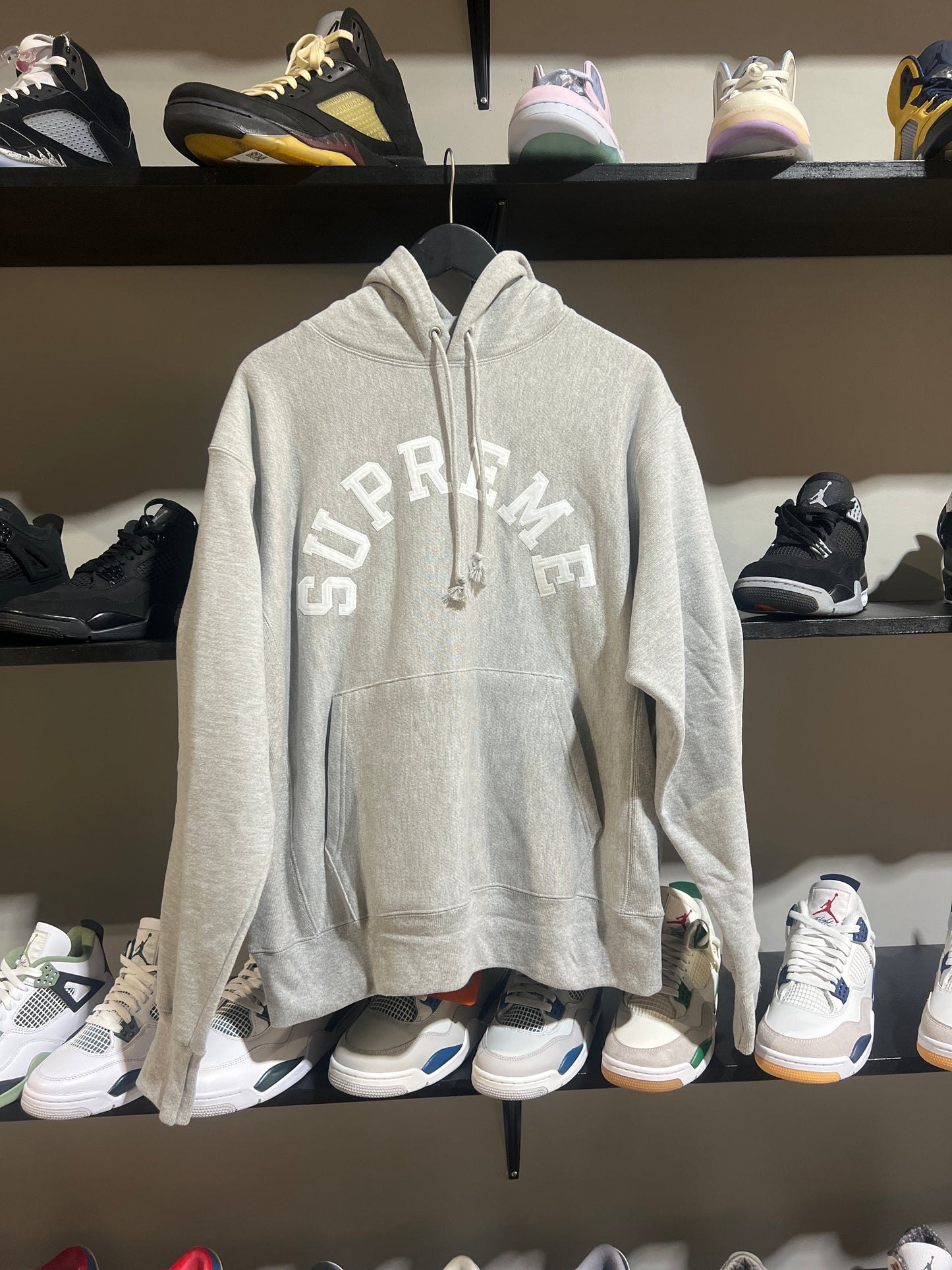 Supreme champion grey and white spell out hood