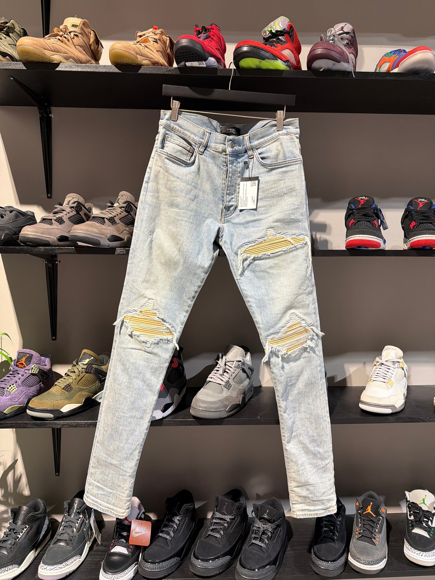 Amiri light wash skinny jeans yellow patches