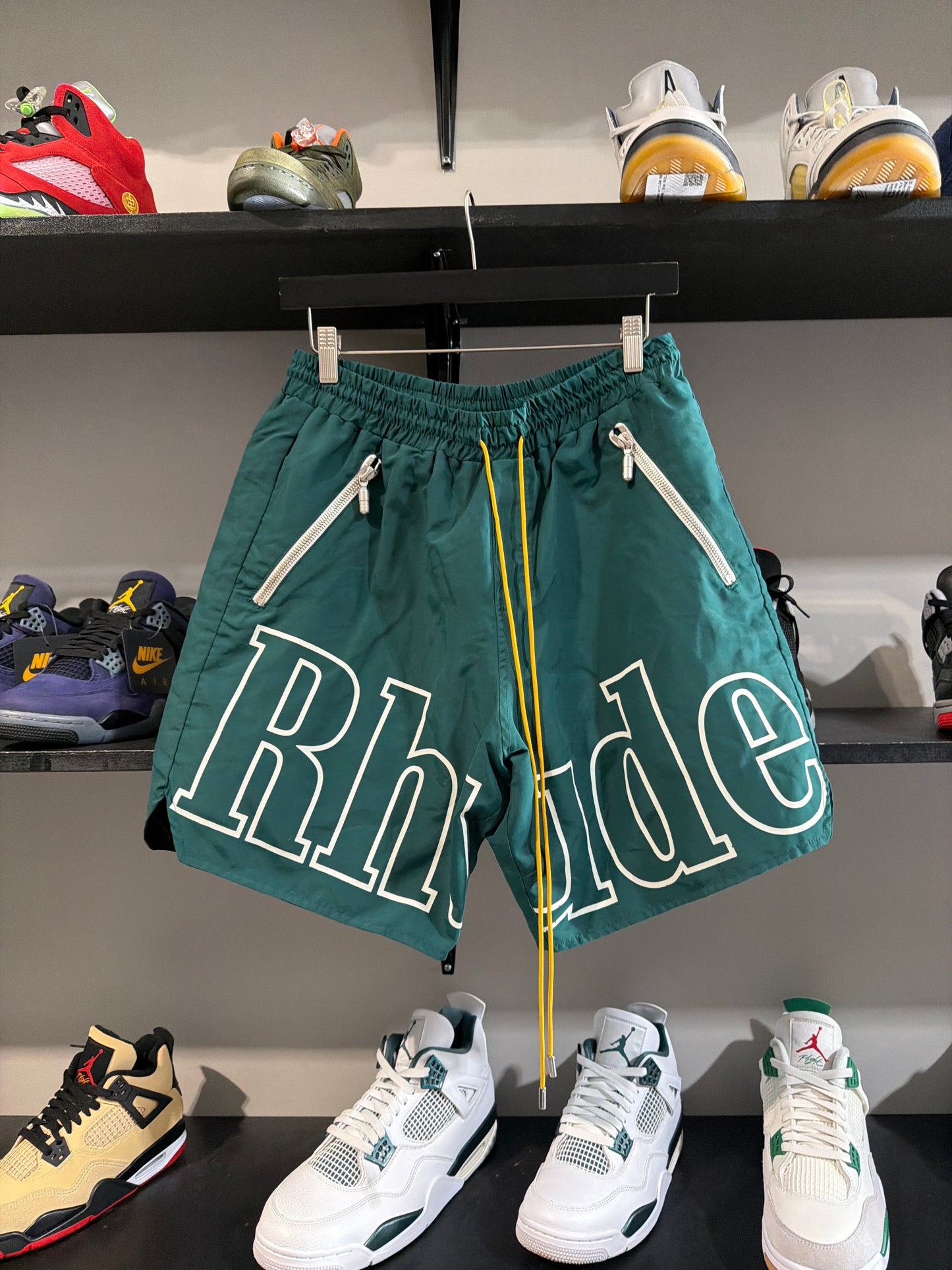 RHUDE GREEN SPELLOUT SHORTS